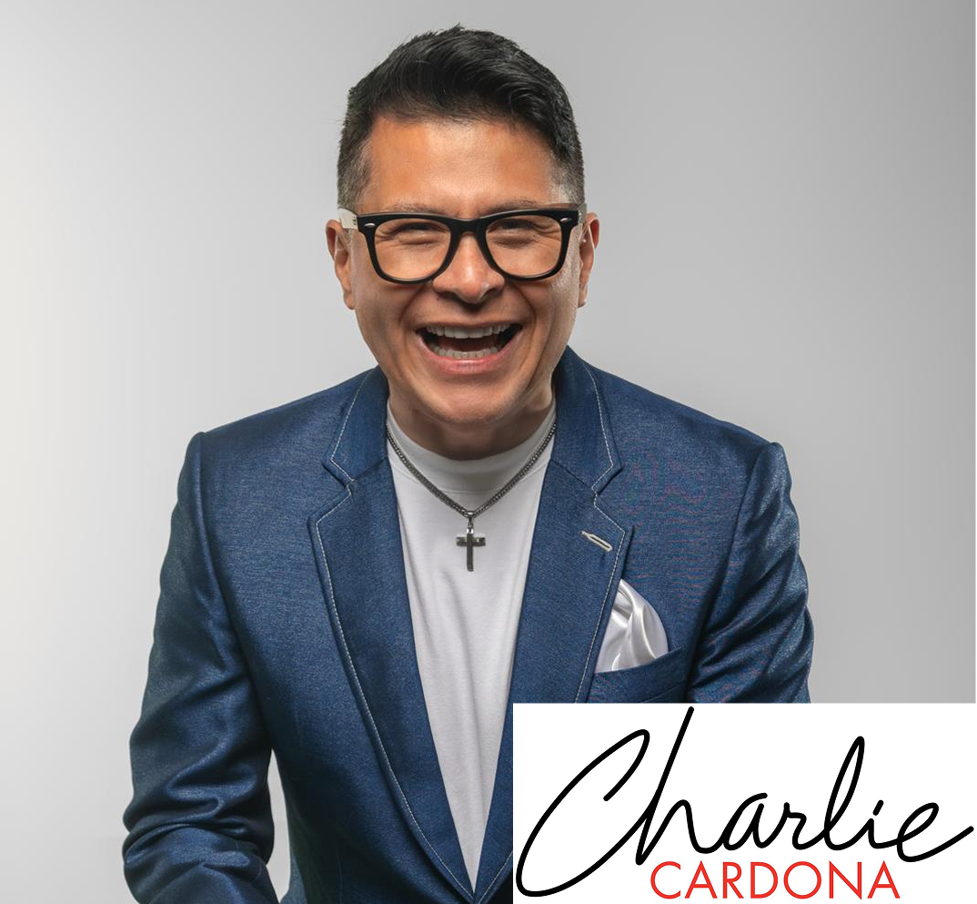 CHARLIE Smiling man in blue suit, white background.